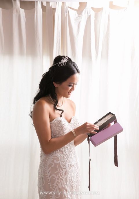 Bride opening gift from groom